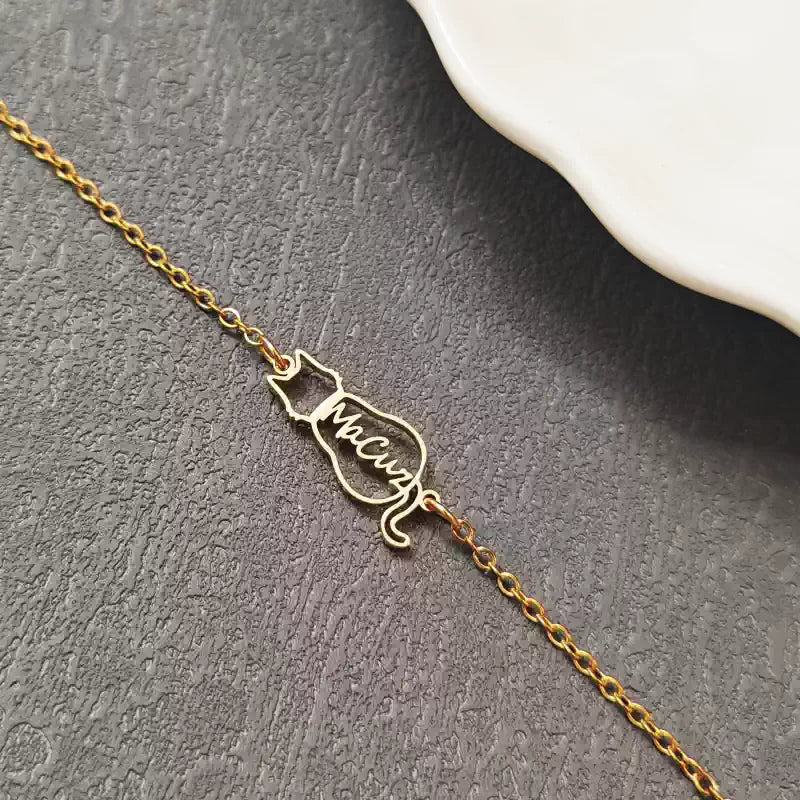 Gold bracelet with a unique design on a dark surface. Cat with name. Stainless Steel Name Jewelry. Custom Gift-Personalized. gift for boyfriend / girlfriend. long-distance relationship gift meaningful keepsake. Memory gift. Christmas couple gift. Birthday Gift. 