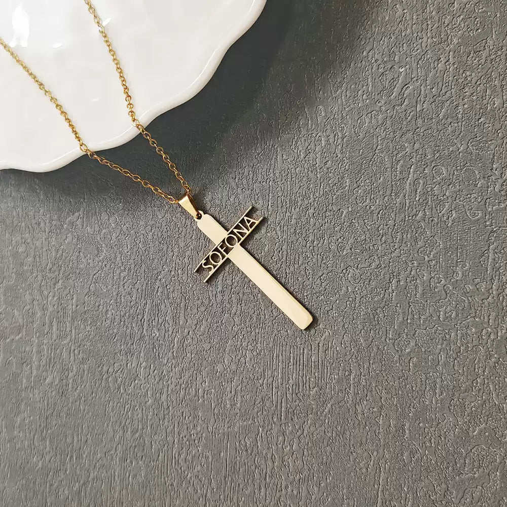 Gold cross necklace with 'Sofia' engraving on a gray surface Stainless Steel Name Jewelry. Custom Gift-Personalized. gift for boyfriend / girlfriend. long-distance relationship gift meaningful keepsake. Memory gift. Christmas couple gift. Birthday Gift. Hollow Letter Cross Necklace