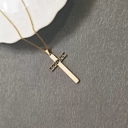 Gold cross necklace with 'Sofia' engraving on a gray surface Stainless Steel Name Jewelry. Custom Gift-Personalized. gift for boyfriend / girlfriend. long-distance relationship gift meaningful keepsake. Memory gift. Christmas couple gift. Birthday Gift. Hollow Letter Cross Necklace