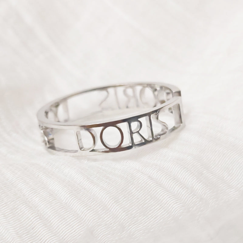 Silver ring with 'Dior' engraving on a white background. Stainless Steel Name Jewelry. Custom Gift-Personalized. gift for boyfriend / girlfriend. long-distance relationship gift meaningful keepsake. Memory gift. Christmas couple gift. Birthday Gift. Bold Initial Frame