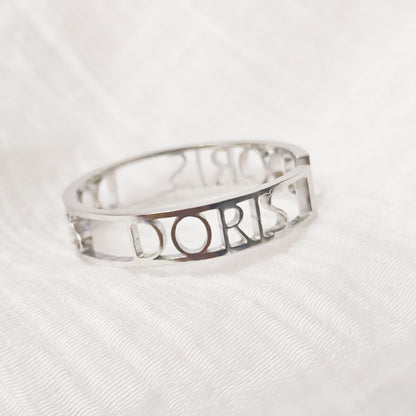 Silver ring with 'Dior' engraving on a white background. Stainless Steel Name Jewelry. Custom Gift-Personalized. gift for boyfriend / girlfriend. long-distance relationship gift meaningful keepsake. Memory gift. Christmas couple gift. Birthday Gift. Bold Initial Frame