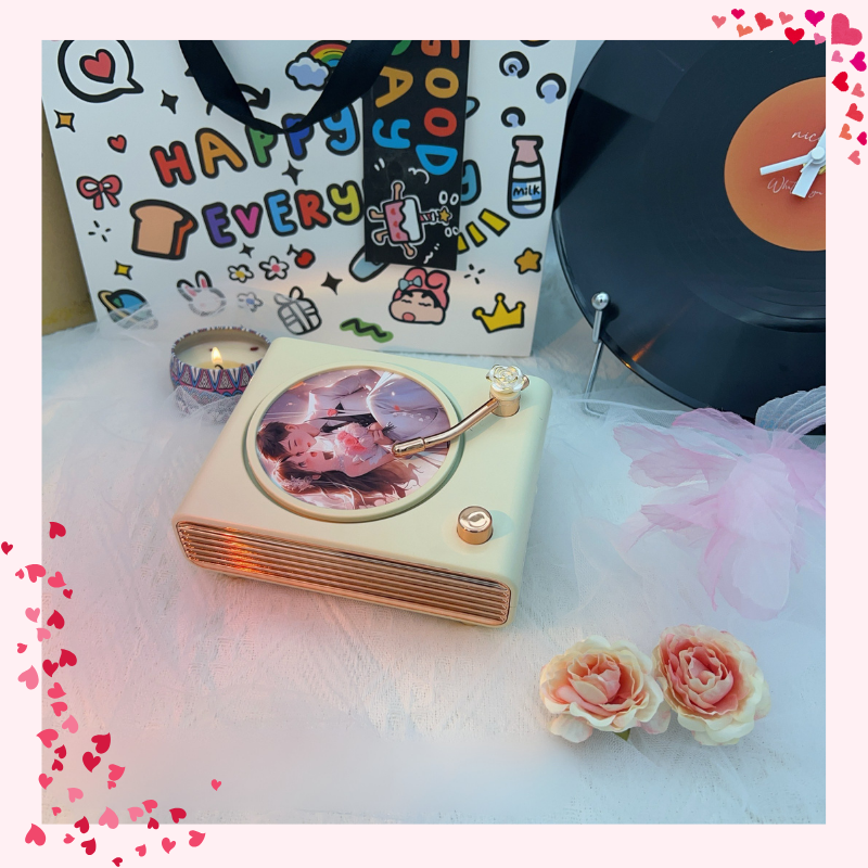 Decorative cake with record player design on a table with flowers and a colorful bag in the background.Personalized couple present. Gift for boyfriend. Custom-made. Personalized. Perfect gift idea. Meaningful keepsake