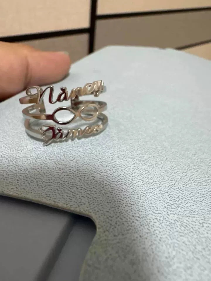 Silver ring with 'Nana' engraved on it, held by a hand against a light background. Stainless Steel Name Jewelry. Custom Gift-Personalized. gift for boyfriend / girlfriend. long-distance relationship gift meaningful keepsake. Memory gift. Christmas couple gift. Birthday Gift. Infinity Embrace