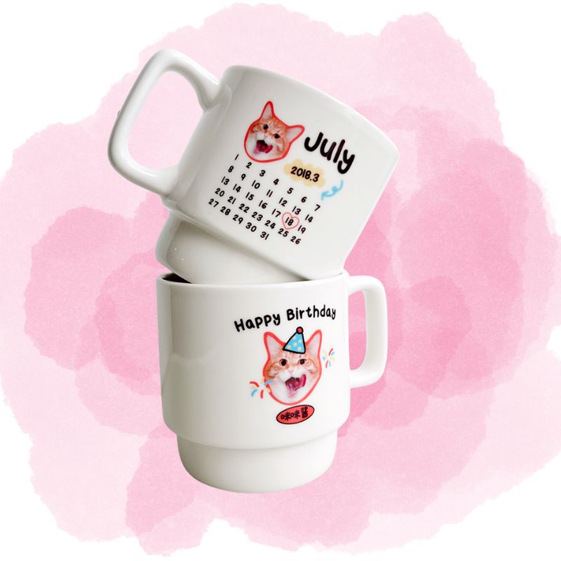 Two mugs with cartoon dog designs and text on a pink watercolor background