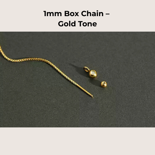 Gold box chain necklace with clasp on a dark gray background