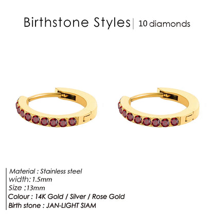 Gold hoop earrings with red gemstones on a white background