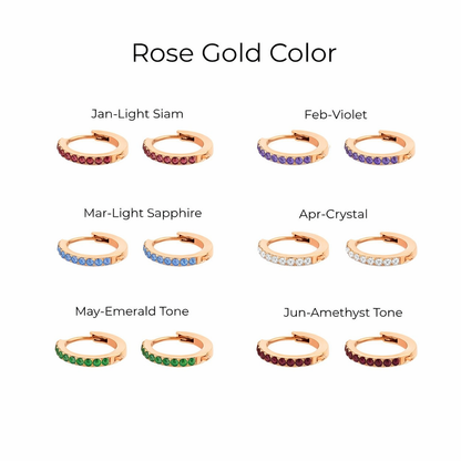 Rose gold hoop earrings with gemstones labeled by month for color matching.