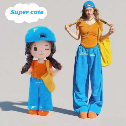 Real person and a Q-style figure wearing matching outfits with blue pants and orange tops, labeled 'Super cute'. Personalized couple present. Gift for boyfriend girlfriend. Custom-made. Personalized. Perfect gift idea. Meaningful keepsake. Wedding gift. Anniversary gift. Birthday gift