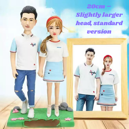 Two figurines in matching outfits standing next to a framed picture of themselves, with text indicating size and type. 20cm figurines. Personalized couple present. Gift for boyfriend girlfriend. Custom-made. Personalized. Perfect gift idea. Meaningful keepsake. Wedding gift. Anniversary gift. Birthday gift